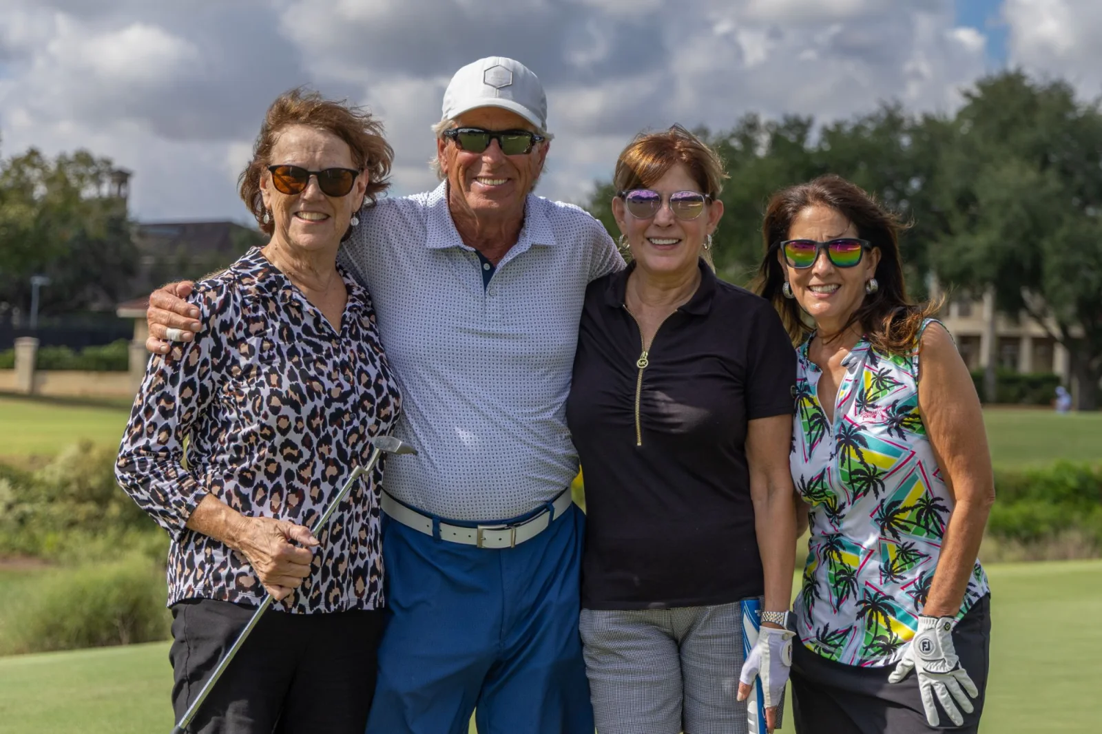 Foursome photographed on the green at the Golf Fore Autism tournament