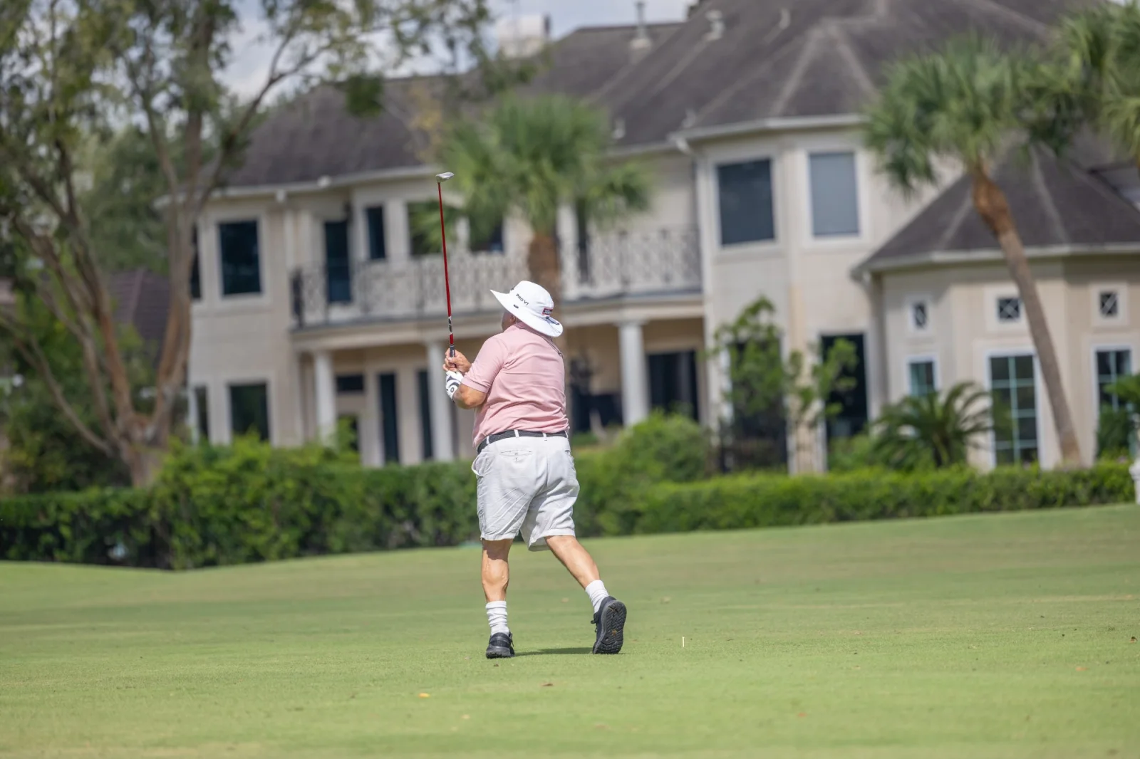Foursome photographed on the fairway at a charity golf tournament