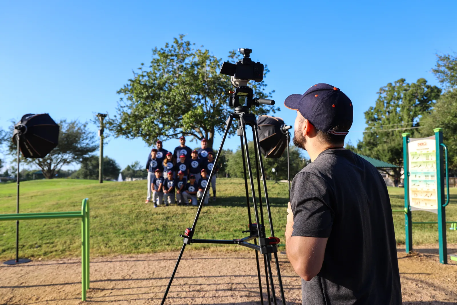 A full team lined up between two softboxes for their group frame
