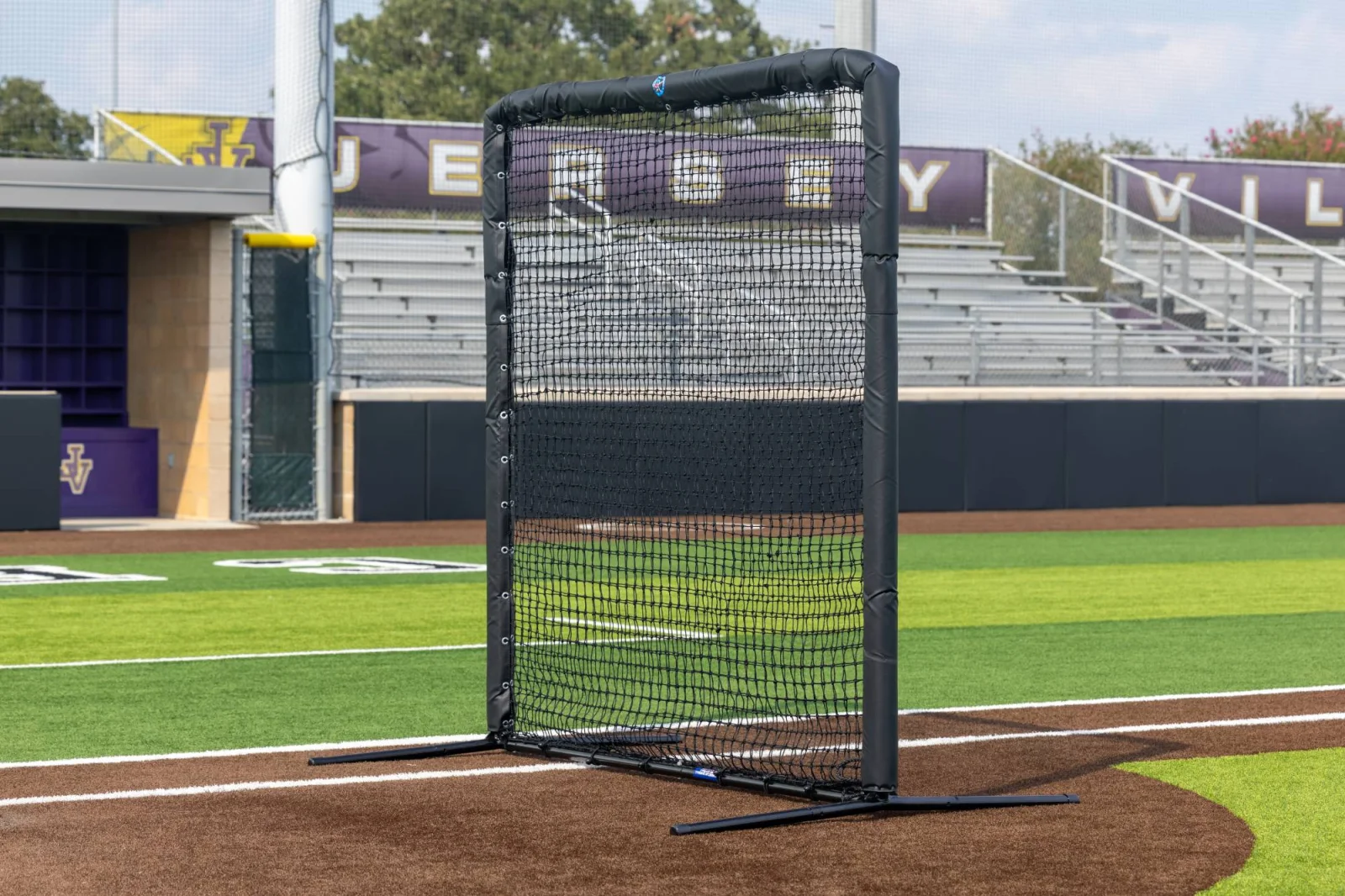 L-screen staged along the foul line at a high school stadium