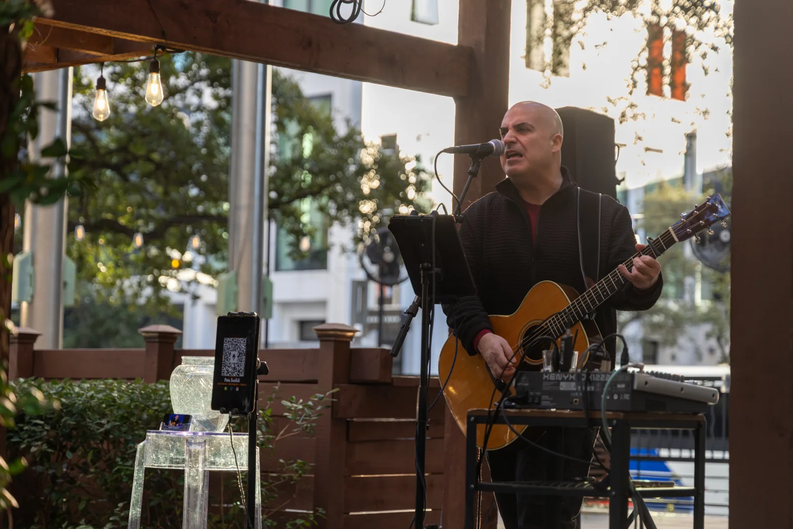 Live musician performing on the patio stage during the reception