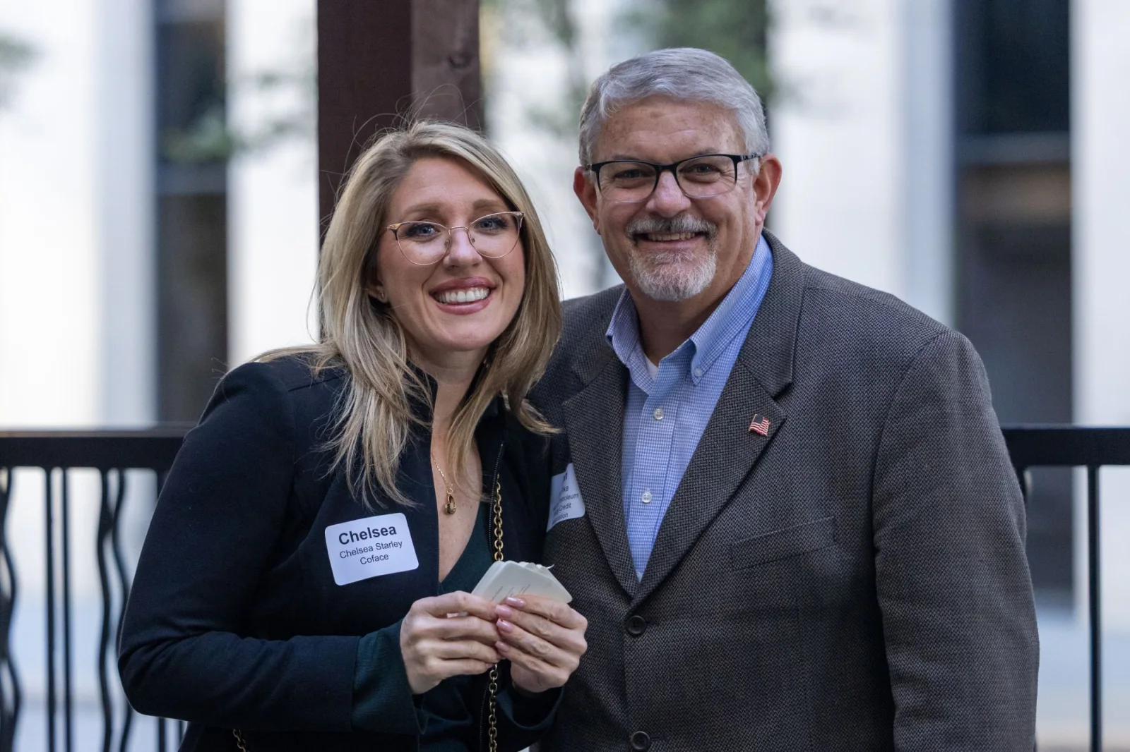 Two attendees photographed together at a trade association reception