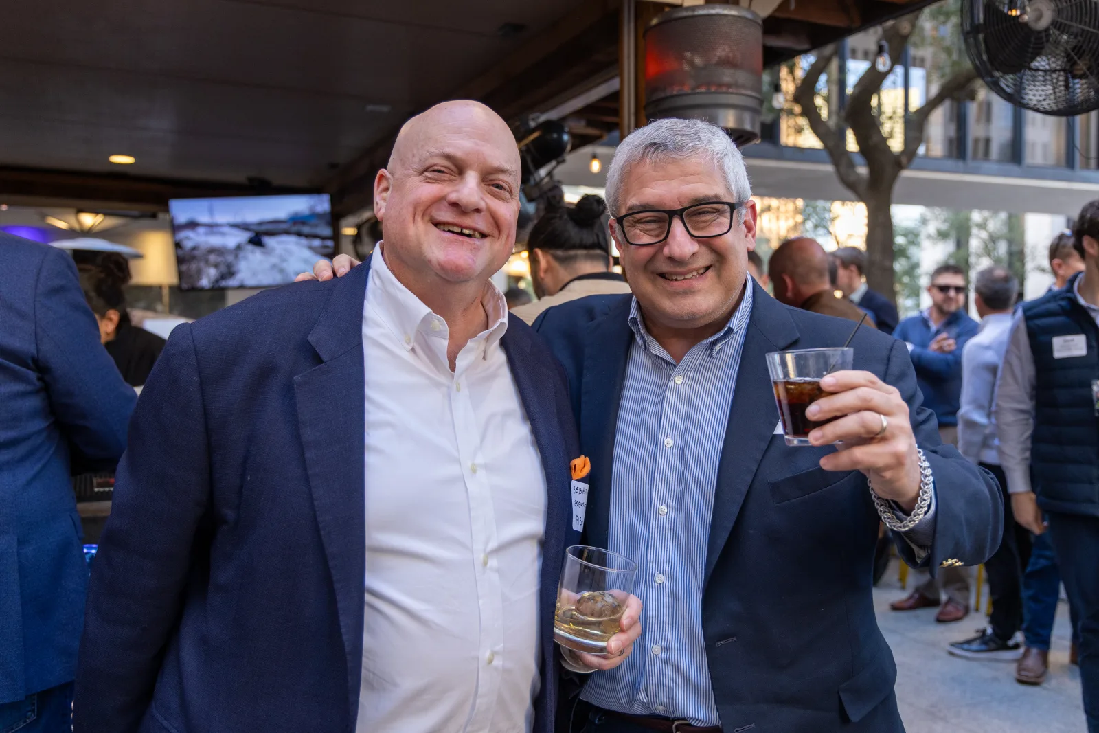 Two members posed together with drinks during the reception