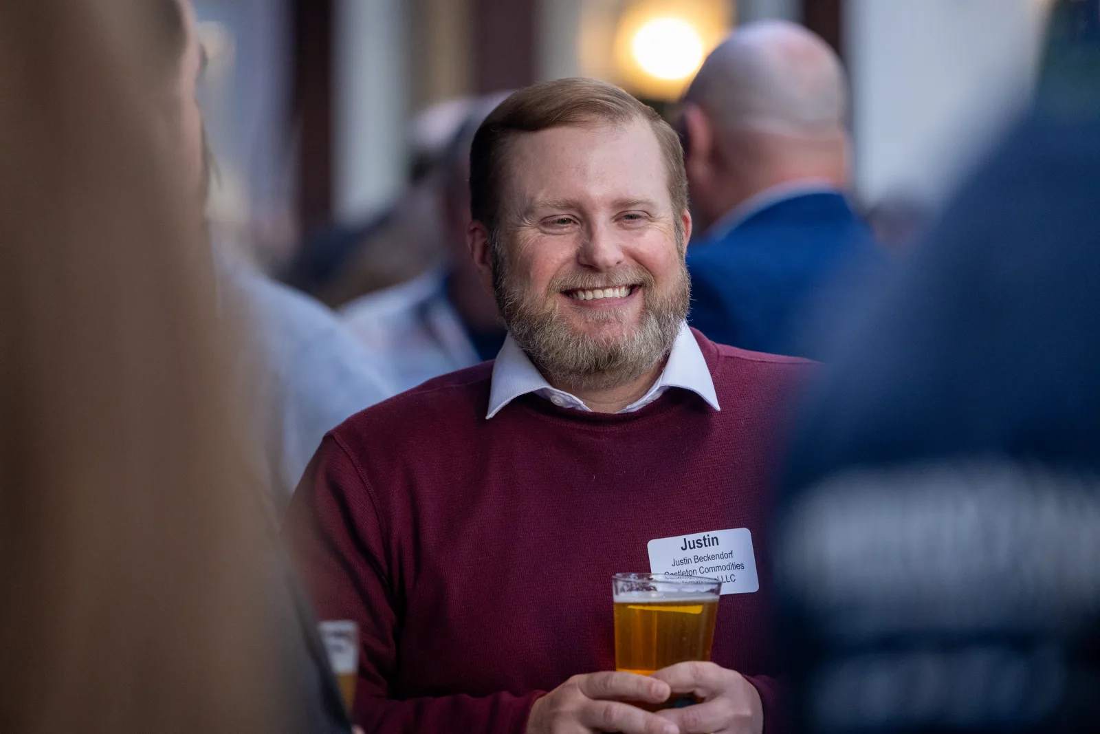 Candid portrait of an attendee holding a drink at the reception