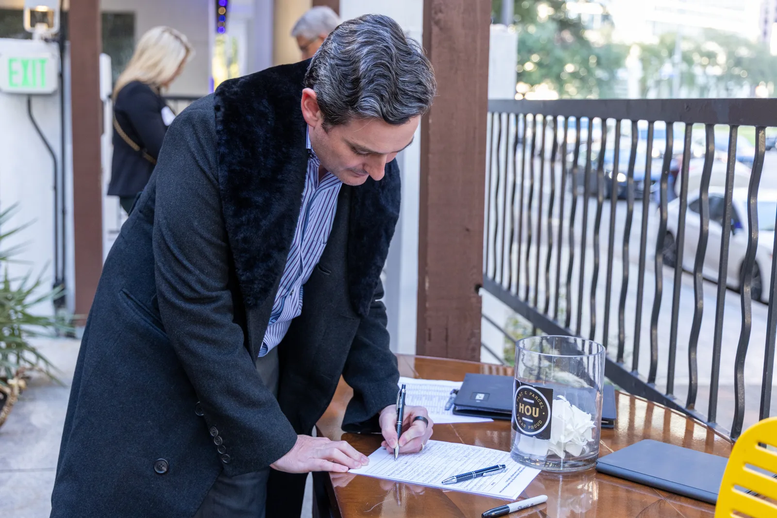 Attendee signing in at the registration table as the reception opens