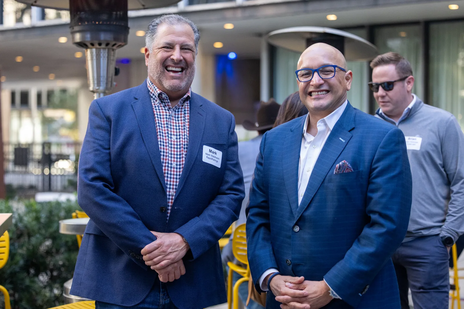 Three members laughing together at an NPECA reception