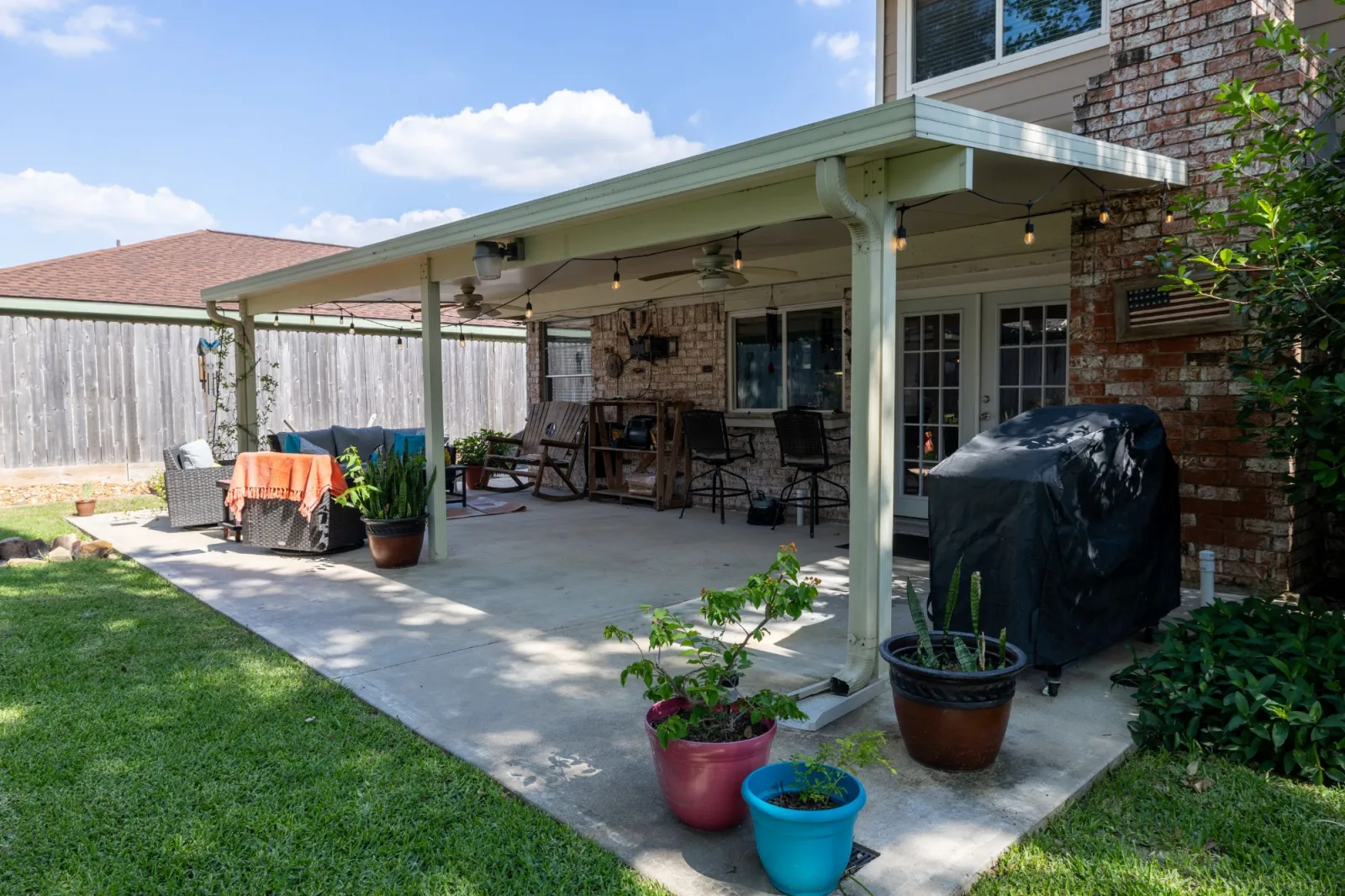 Covered patio and outdoor living area at a Meadows Place listing