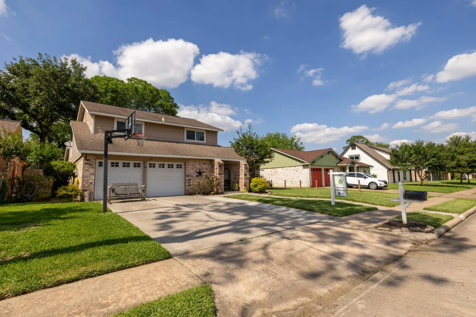 Meadows Place, Texas listing exterior with the Homes by Combs sign in the front yard